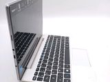 a white laptop with a black keyboard on a white surface