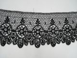 a close up of a black lace on a white background