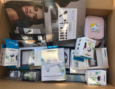 a cardboard box full of electronic gadgets and other items