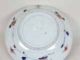 a white plate with blue and orange flowers on it