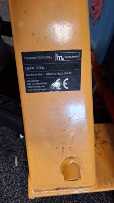 a close up of a yellow machine on the ground