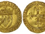 une pièce d'or sur laquelle figurent une croix et une couronne