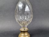 an image of a clear glass vase on a gold stand