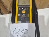 a yellow and black digital multimeter with a note attached to it