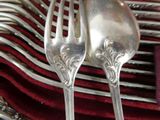 two forks that are sitting on top of a red napkin