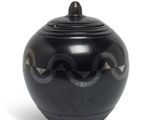 an image of a black vase with a wavy design on it