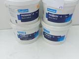three buckets of paint sitting on top of a white table