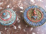 pair of antique brass and enamel jewelry boxes on a marble table
