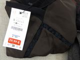 a bag with a price tag on it sitting on a couch