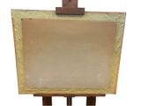 a wooden easel with a painting on it on a white background