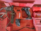 a red box with a drill and other tools in it