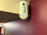 a white toilet paper dispenser mounted on a red wall