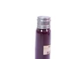 a purple bottle with a silver lid on a white surface