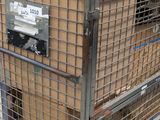 a metal cage with a box on top of it