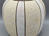 a white vase with a cracky design on it