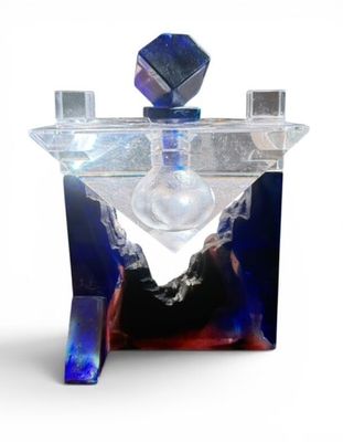a glass perfume bottle with a blue and purple design on it