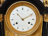 a black and gold clock sitting on a table