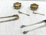 a lot of silver spoons and spoons on a table