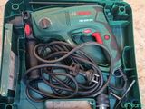 a green box with a drill and other tools in it