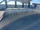 tables and chairs are lined up in a row under a canopy