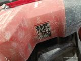 a close up of a red and black motorcycle with a red handlebar