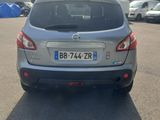 the back end of a silver car parked in a parking lot