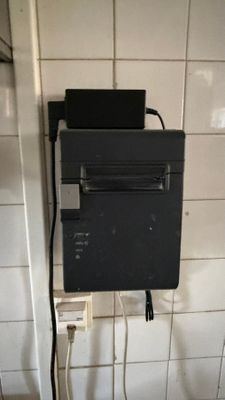 a black box with a printer on top of it in a bathroom