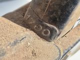 a close up of a piece of wood with a hammer on it
