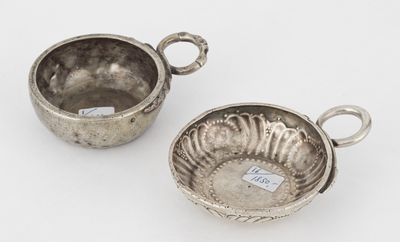 two silver dishes with handles and handles on a white surface