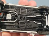 a person holding a toy car in their hand