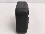 a small black camera sitting on a white table
