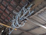 a metal sign hanging from the ceiling of a building