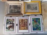 many framed pictures on the wall of a room