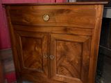 a wooden cabinet with a drawer on top of it