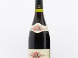 a bottle of wine sitting on top of a white table