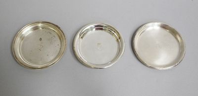three silver trays on a table with one empty and one empty