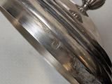 a close up of a silver plate on a table