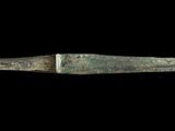 a knife that is sitting on a black surface