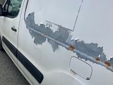 a man standing next to a van that has been vandalized