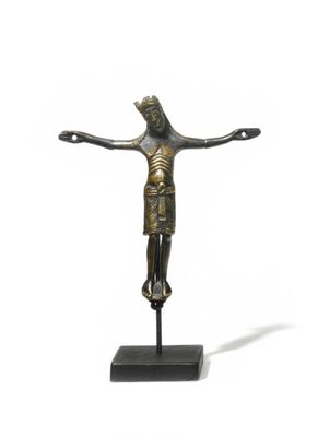an image of a bronze statue of a person on a cross