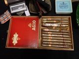 a box of cigars sitting on a table next to other cigars