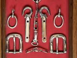 an image of a display case with a bunch of different types of horse bridles