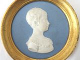 gold framed picture of a woman with a blue background
