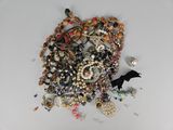 a pile of assorted jewelry on a white surface