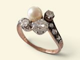une image d'une bague en perles et diamants sur fond blanc