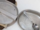 a small tin with a spoon in it on a table