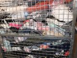 a metal cart with many items in it in a warehouse