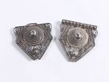 pair of antique silver earrings on a white background