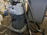 a vacuum that is sitting on the floor in a room