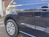 a blue car parked in a parking lot with its door open